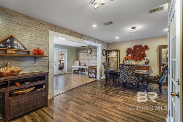 dining space with dark hardwood / wood-style flooring