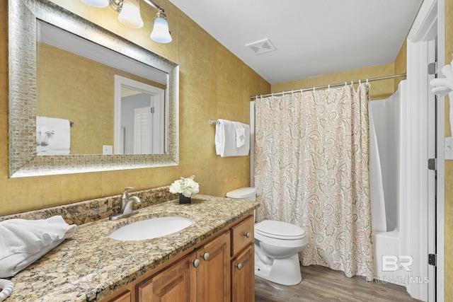 full bathroom with vanity, toilet, shower / bath combination with curtain, and hardwood / wood-style floors