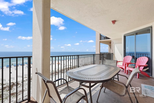 balcony with a beach view and a water view