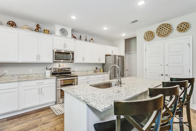 kitchen featuring sink, white cabinets, and appliances with stainless steel finishes