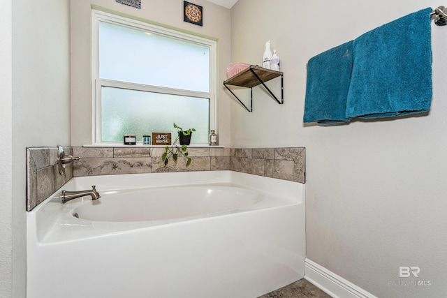 bathroom featuring a healthy amount of sunlight and a washtub