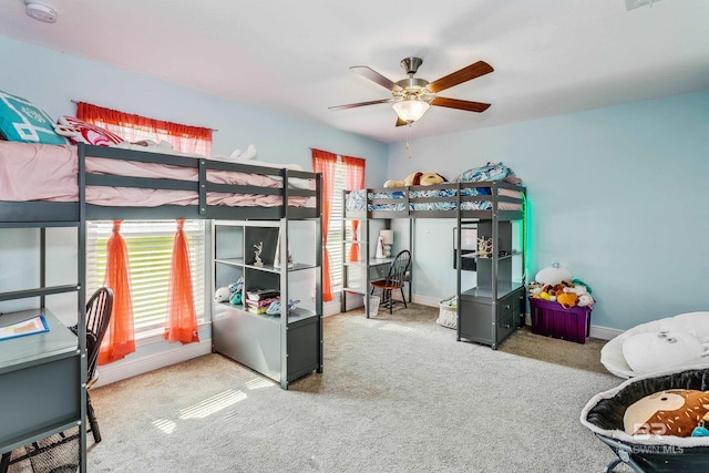 bedroom featuring multiple windows, ceiling fan, and carpet