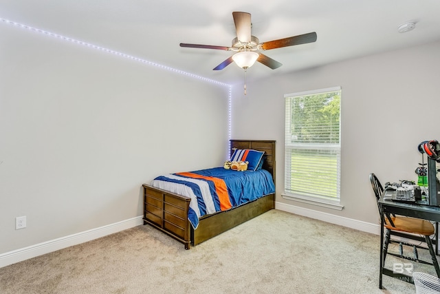 bedroom featuring light carpet and ceiling fan