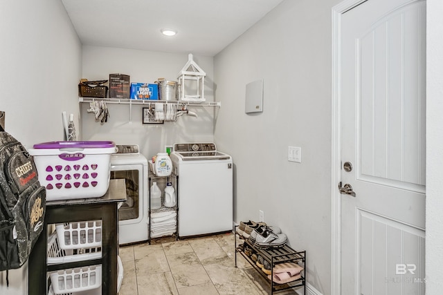 clothes washing area with washing machine and clothes dryer