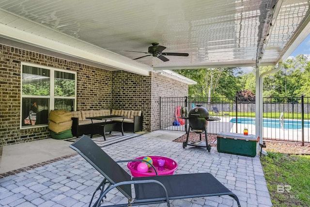 view of patio with a fenced in pool, grilling area, ceiling fan, and outdoor lounge area