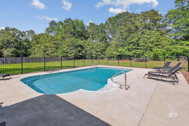 view of swimming pool with a yard and a patio