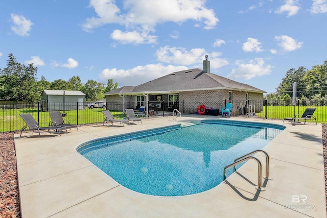 view of pool featuring a patio area and a lawn