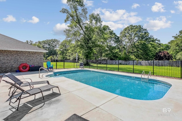 view of pool with a yard and a patio