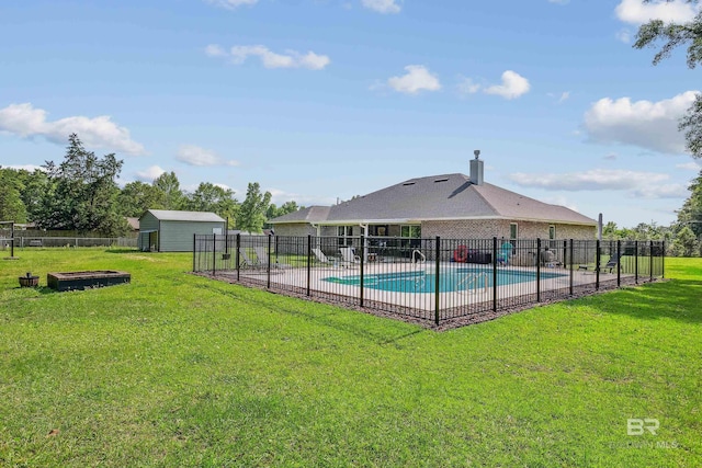 view of pool featuring a yard and an outdoor structure