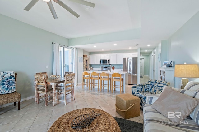 living room with ceiling fan and light tile patterned floors