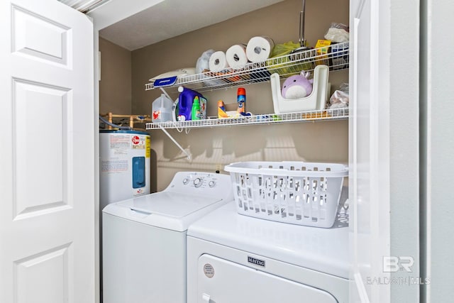 clothes washing area with washer and dryer and electric water heater