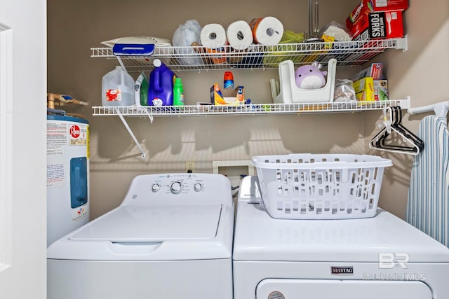 clothes washing area with washer and clothes dryer and water heater