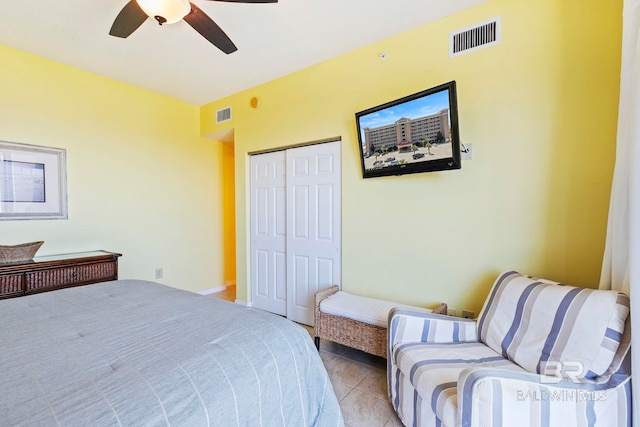 tiled bedroom with a closet and ceiling fan