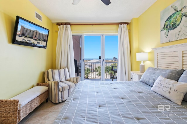 tiled bedroom featuring a textured ceiling, ceiling fan, and access to exterior