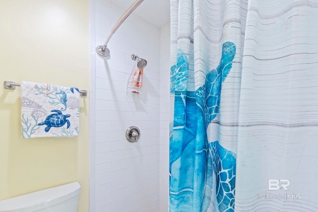 bathroom with toilet and curtained shower