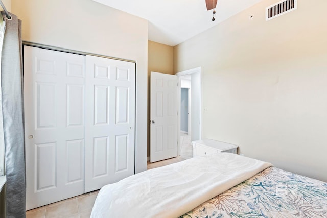 tiled bedroom with a closet and ceiling fan