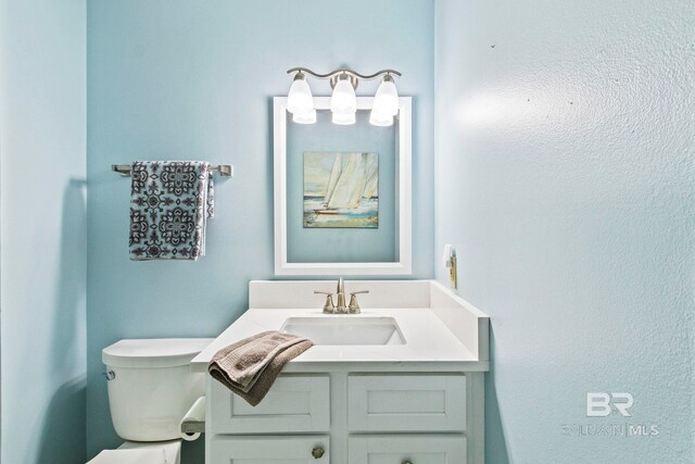 bathroom with vanity and toilet