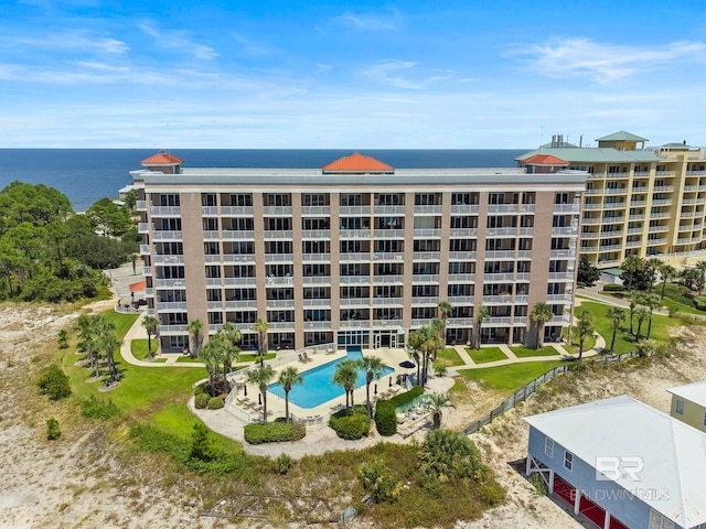 view of property with a water view and a community pool