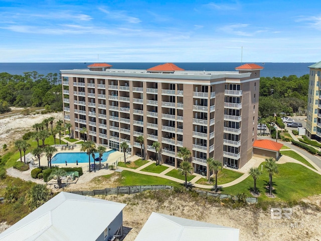 view of property featuring a community pool and a water view