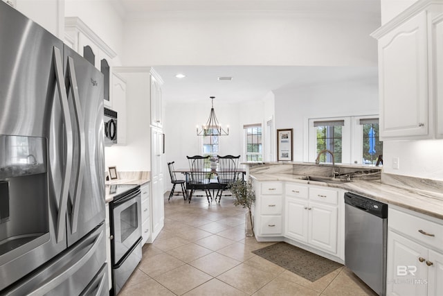 kitchen featuring pendant lighting, sink, appliances with stainless steel finishes, white cabinetry, and light stone counters