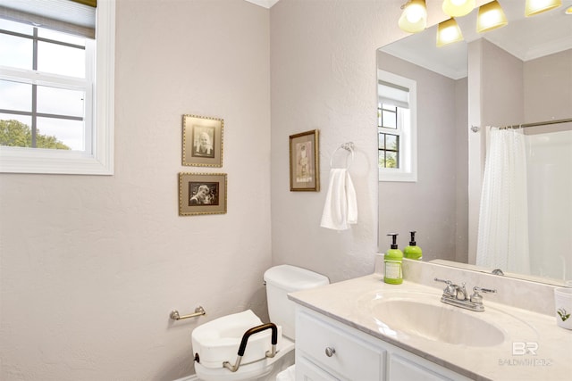 bathroom with vanity, toilet, crown molding, and a shower with shower curtain