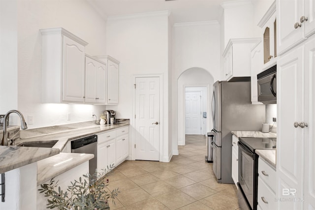 kitchen featuring light tile patterned floors, sink, white cabinetry, and black appliances