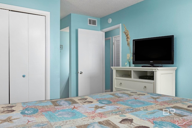 unfurnished bedroom with a textured ceiling and a closet