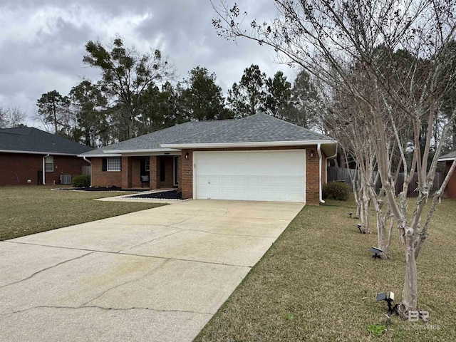 ranch-style home featuring a garage, central AC, and a front lawn