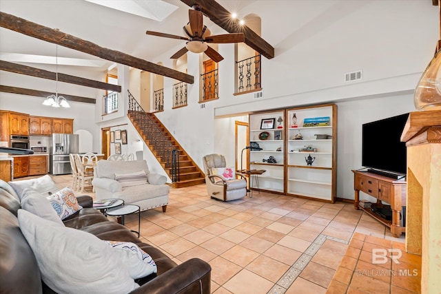 living room featuring beamed ceiling, ceiling fan with notable chandelier, high vaulted ceiling, and light tile patterned flooring