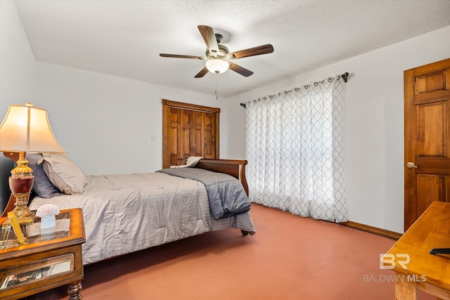 carpeted bedroom featuring ceiling fan and a textured ceiling