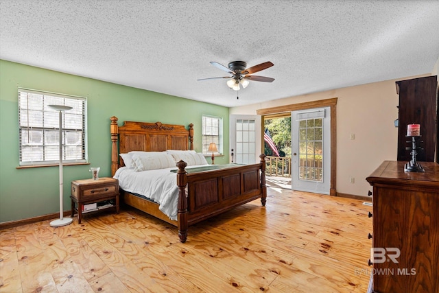 bedroom featuring multiple windows, access to outside, light wood-type flooring, and ceiling fan