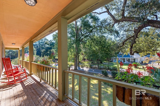 deck with a lawn and a porch