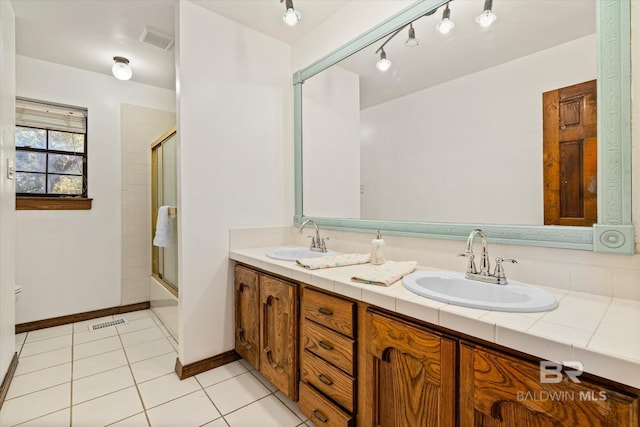 bathroom featuring rail lighting, tile patterned floors, vanity, and combined bath / shower with glass door