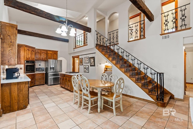 tiled dining room featuring beamed ceiling, a notable chandelier, and high vaulted ceiling