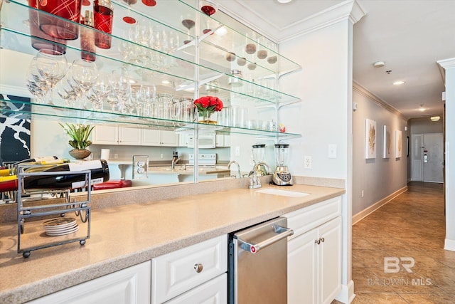 bar featuring white cabinets, light tile patterned floors, ornamental molding, sink, and stainless steel dishwasher