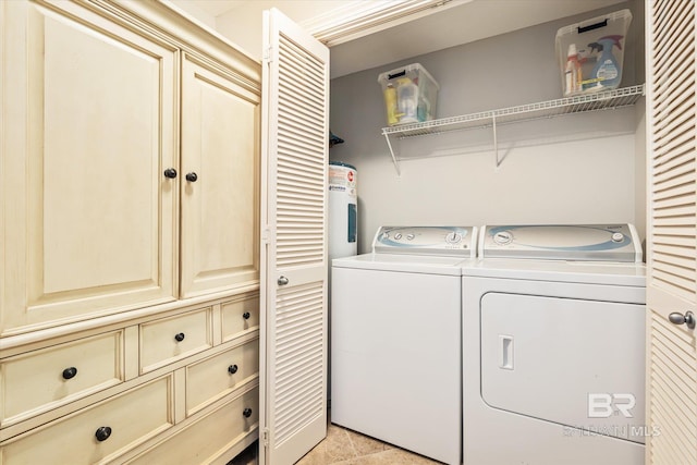 clothes washing area with light tile patterned floors and washer and dryer