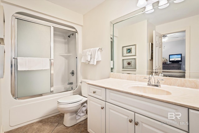 full bathroom with shower / bath combination with glass door, tile patterned floors, ceiling fan, vanity, and toilet