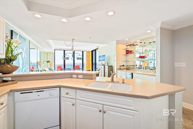 kitchen with crown molding, dishwasher, white cabinetry, and sink