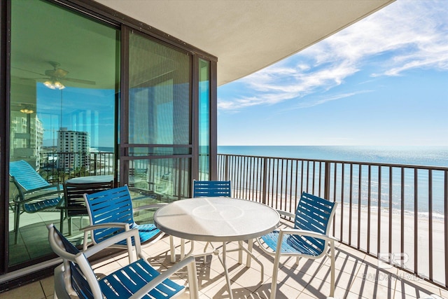 balcony featuring a water view and a beach view