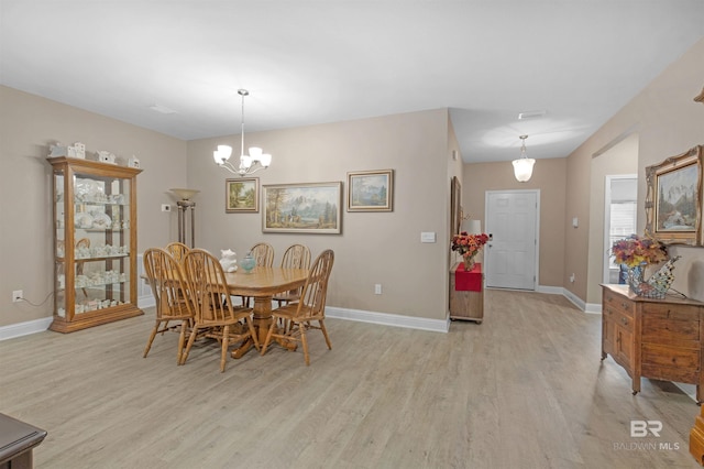 dining room featuring light hardwood / wood-style flooring and a chandelier