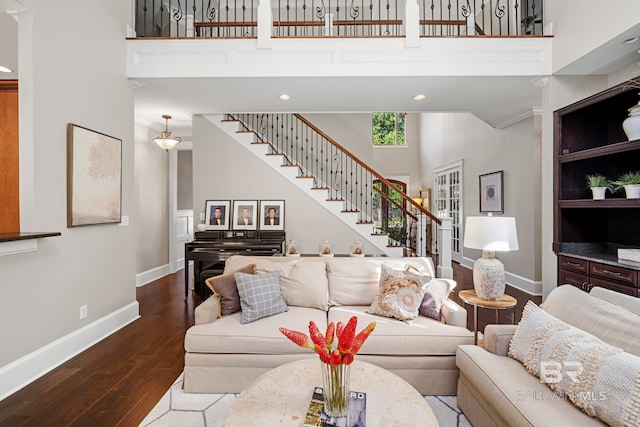 living room with a high ceiling and hardwood / wood-style floors