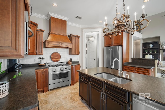 kitchen featuring high quality appliances, ornamental molding, sink, an inviting chandelier, and premium range hood