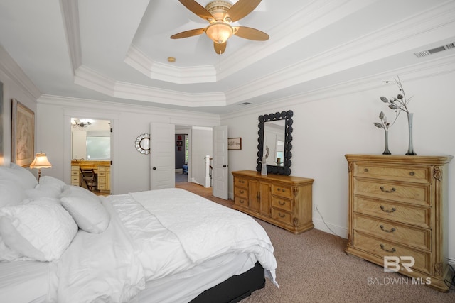 bedroom featuring crown molding, a raised ceiling, light carpet, and ceiling fan