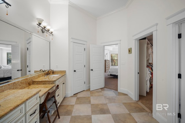 bathroom featuring vanity, ornamental molding, and a high ceiling