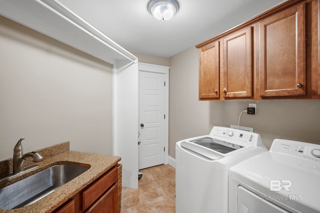 washroom featuring cabinets, sink, washer and clothes dryer, and light tile patterned floors