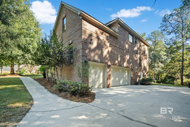 view of side of home featuring a garage