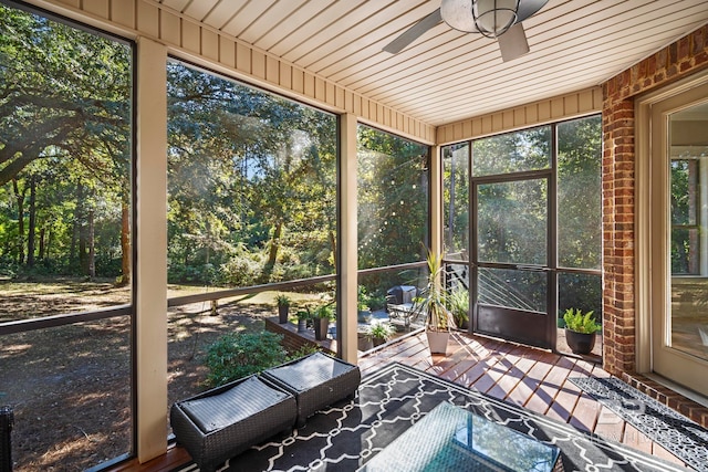 unfurnished sunroom featuring wooden ceiling and ceiling fan