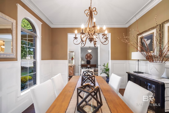 dining room with a notable chandelier, ornamental molding, and wood-type flooring