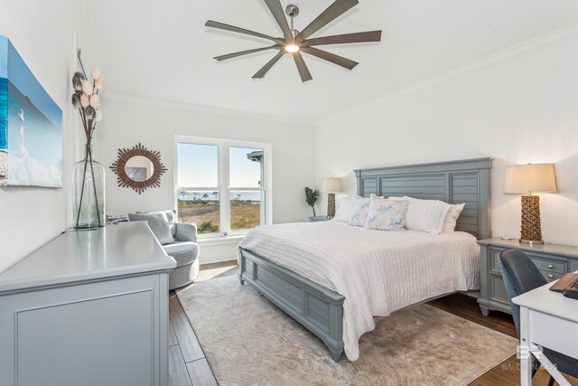 bedroom with light hardwood / wood-style floors, ceiling fan, and ornamental molding