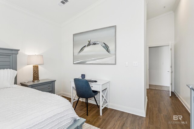 bedroom with dark hardwood / wood-style floors, ornamental molding, and vaulted ceiling